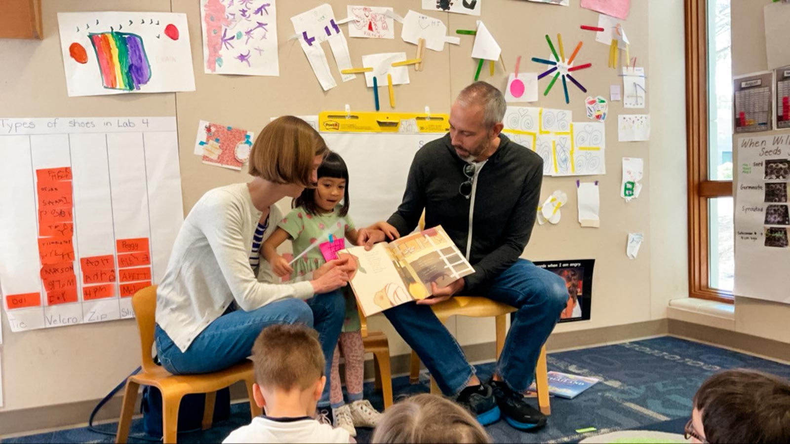 adopted parents read a book with their adopted child from Thailand