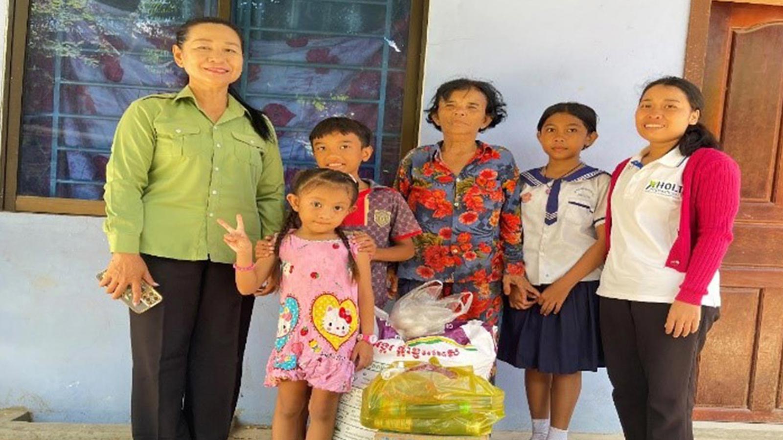 A family with malnourished children in Cambodia receives emergency food relief from a Gift of Hope