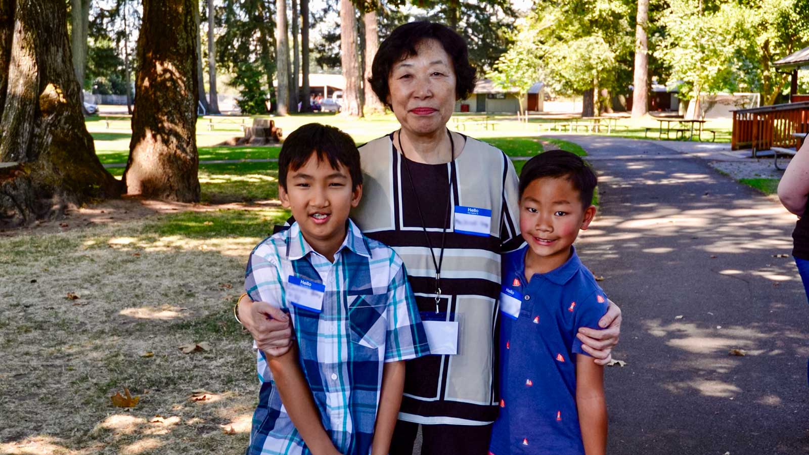 a foster mother is reunited with two foster children she cared for at a Holt picnic.