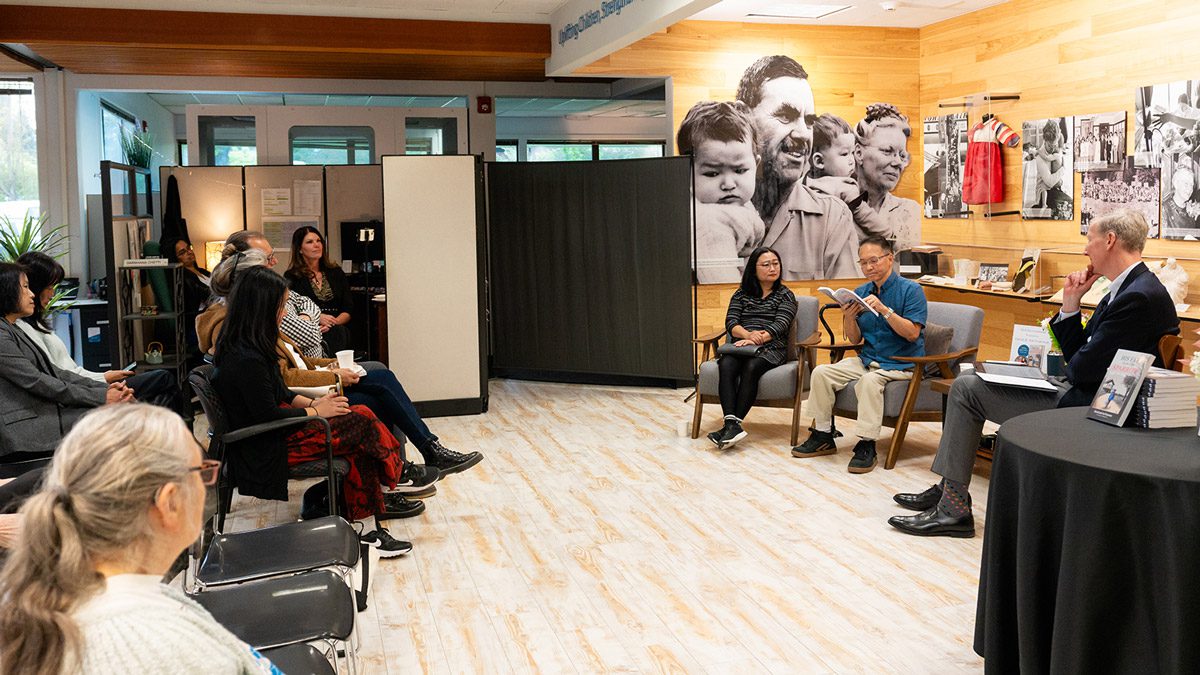 an Korean adoptee and author reads an excerpt from his book at an event.