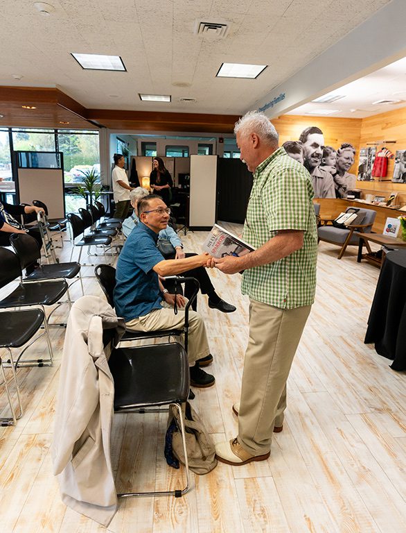 two Korean adoptees shake hands