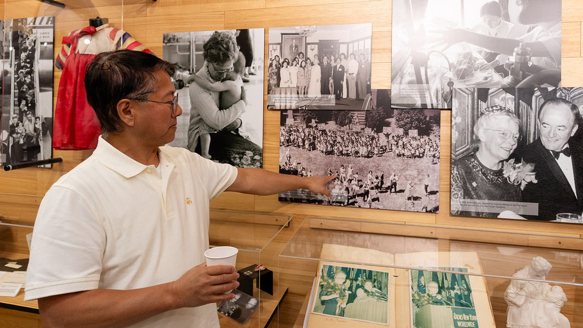 A Holt International staff member points at a historical photo of Korea