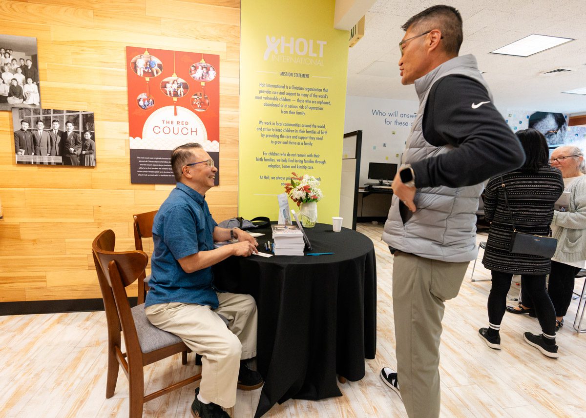 Two Korean adoptees speak to each other at a book event.