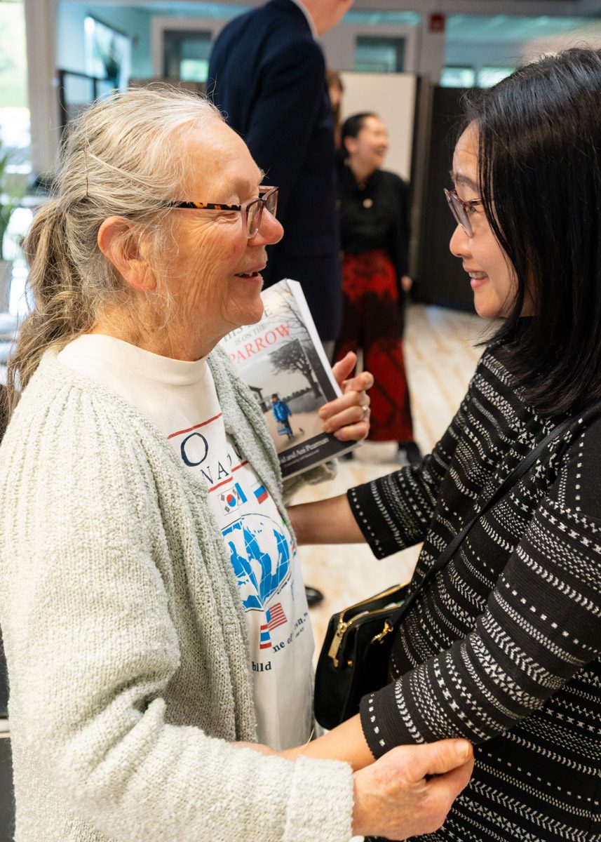 Members of the Holt community mingle at an adoptee book event