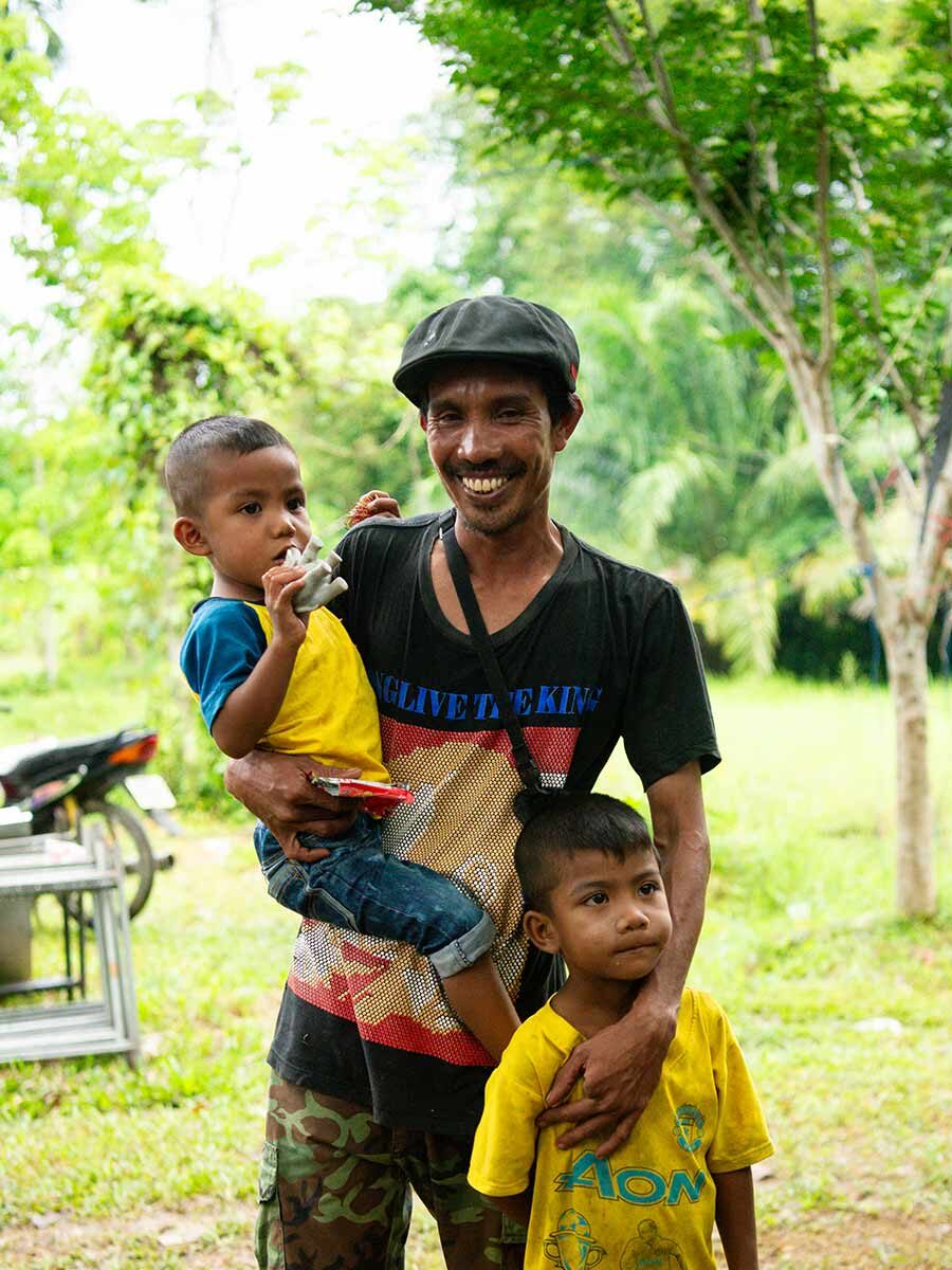 A father in Thailand cares for his children.