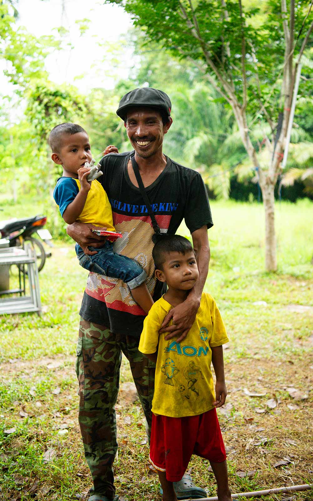 A father in Thailand cares for his children.