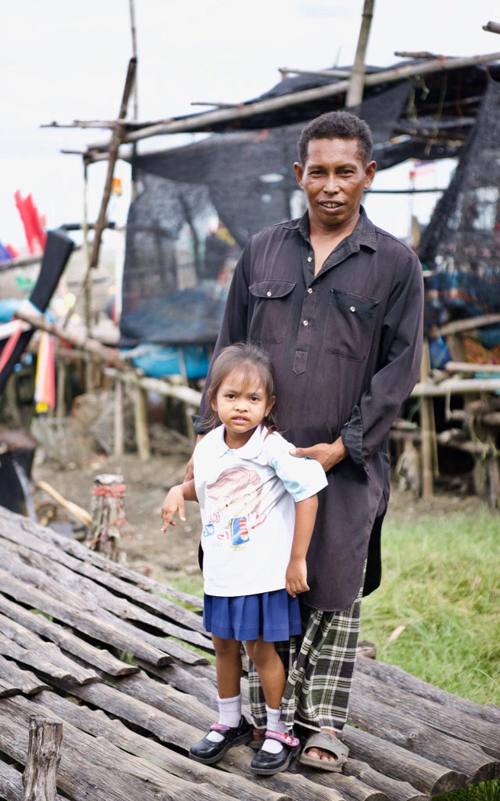 a fisherman dad with his child in Thailand