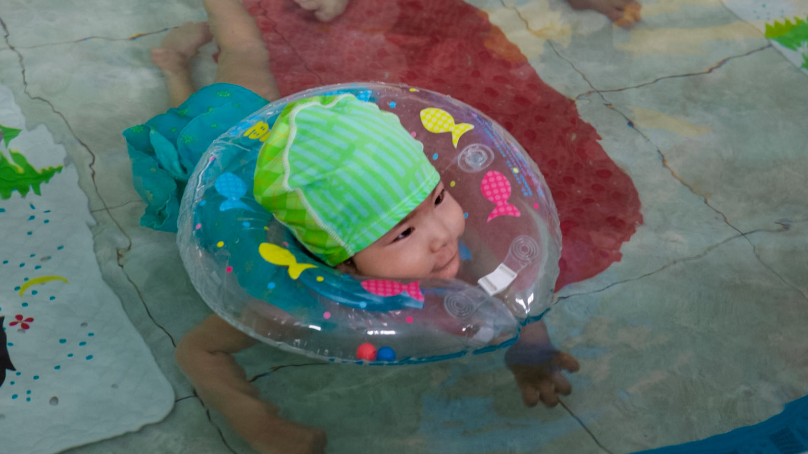 a child with cerebral palsy swims during aqua therapy in china