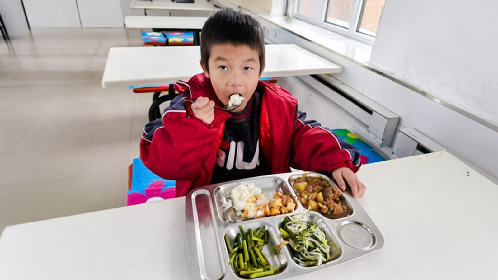 A child in China eats his school lunch because of donor support for education!