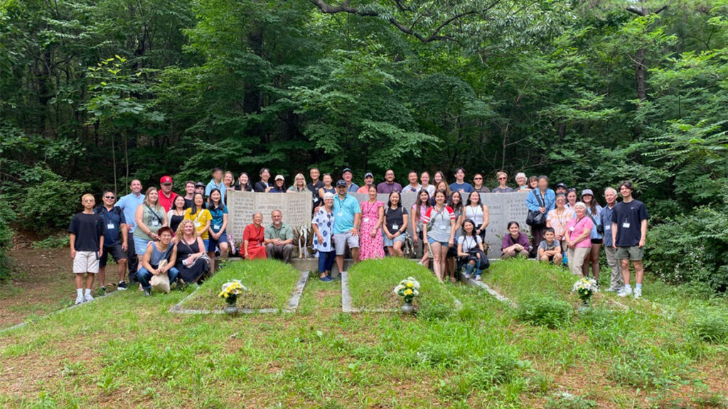 The 2023 Korea Heritage Tour participants visiting Harry and Bertha Holt's graves in Ilsan, Korea.