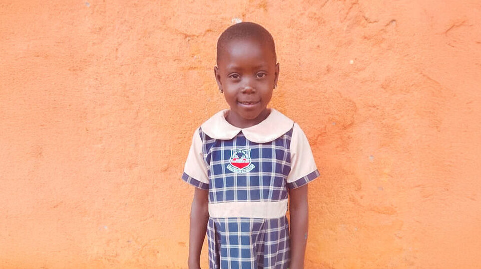 a girl in Uganda waits for her school lunch