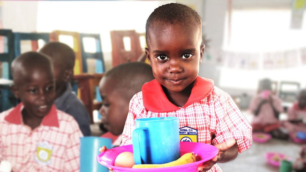 a hungry child receives a lunch through the generosity of donors