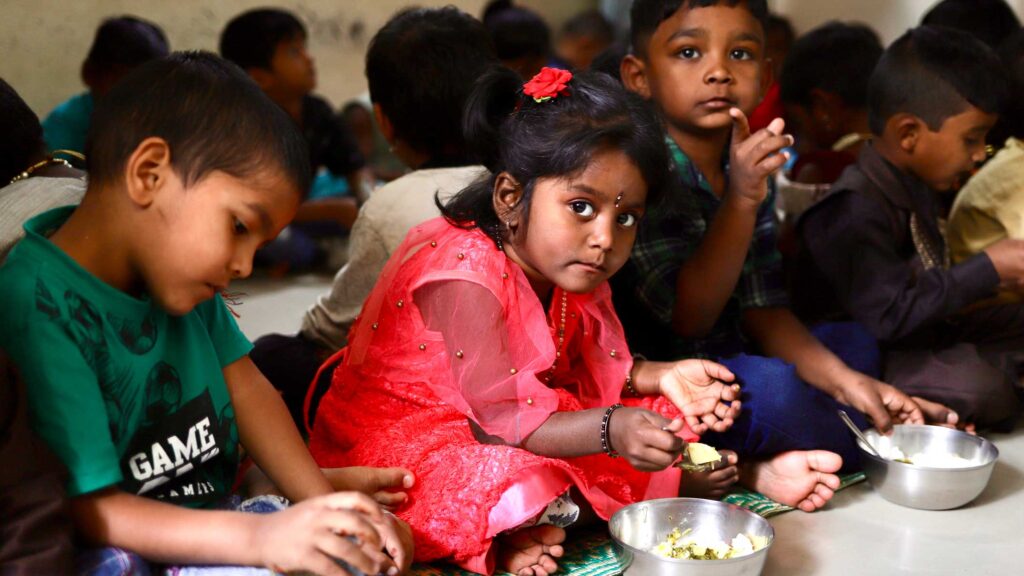 Class full of children eating lunch in India