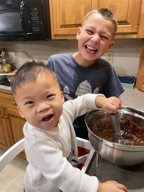 Adopted boy with Down syndrome and his brother