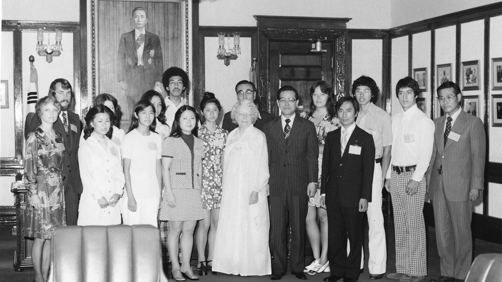 Holt's first motherland tour of Korea in 1975. Bertha Holt and David Kim stand at the center, surrounded by adoptees.