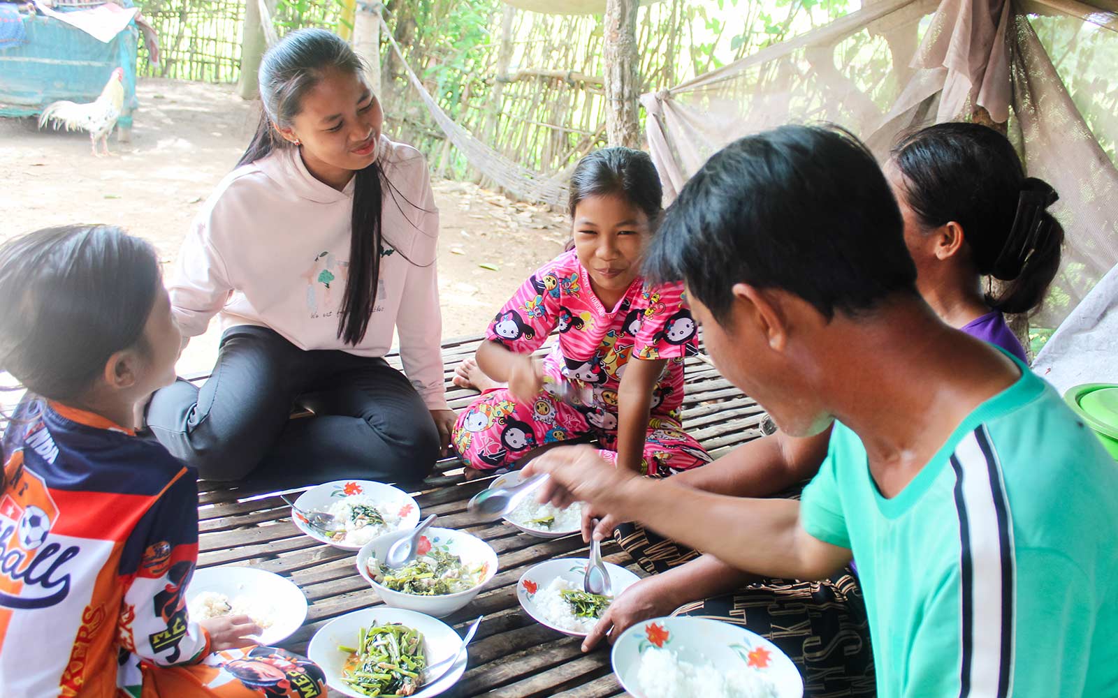 a family in Cambodia shares a nutritious meal, all thanks to donors feeding hungry children
