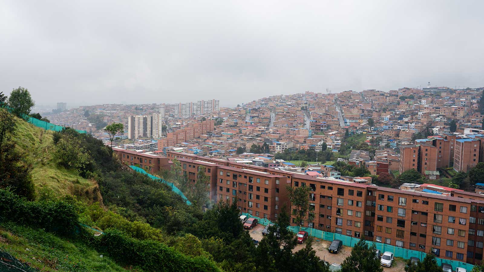 an overlook of Bogota, Colombia, a hillside to the left and the city to the right