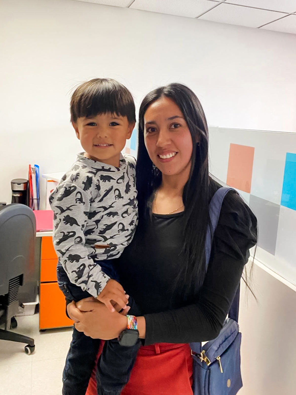 a mom holds her son in her arms at a children's center in colombia