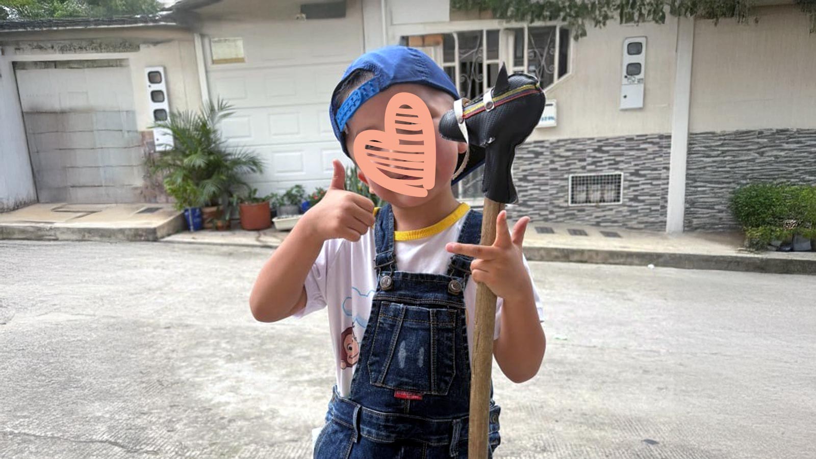 a waiting child smiles outside his house