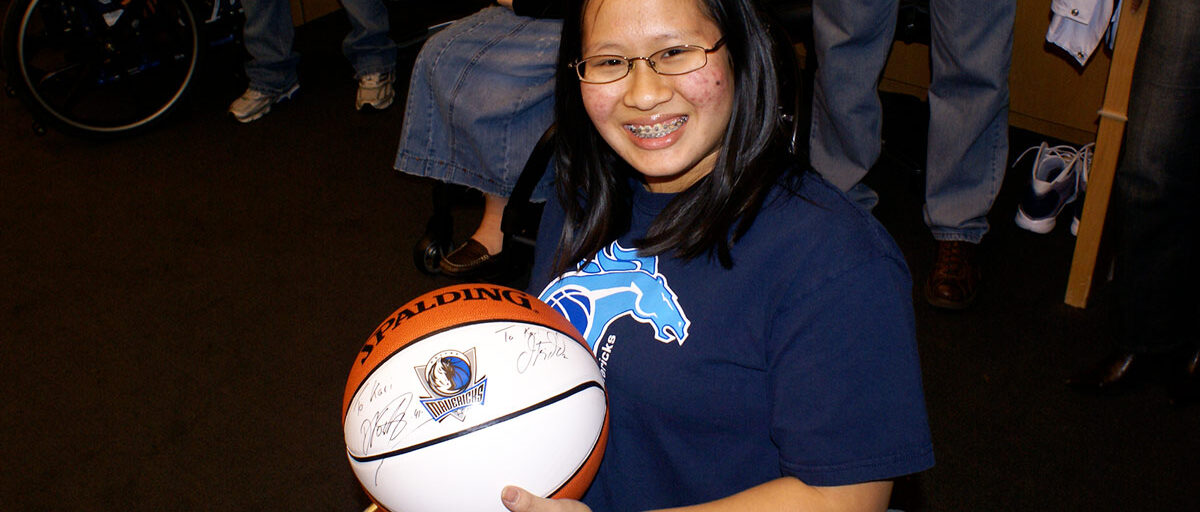 Thai adoptee Kari Banta holding a basketball