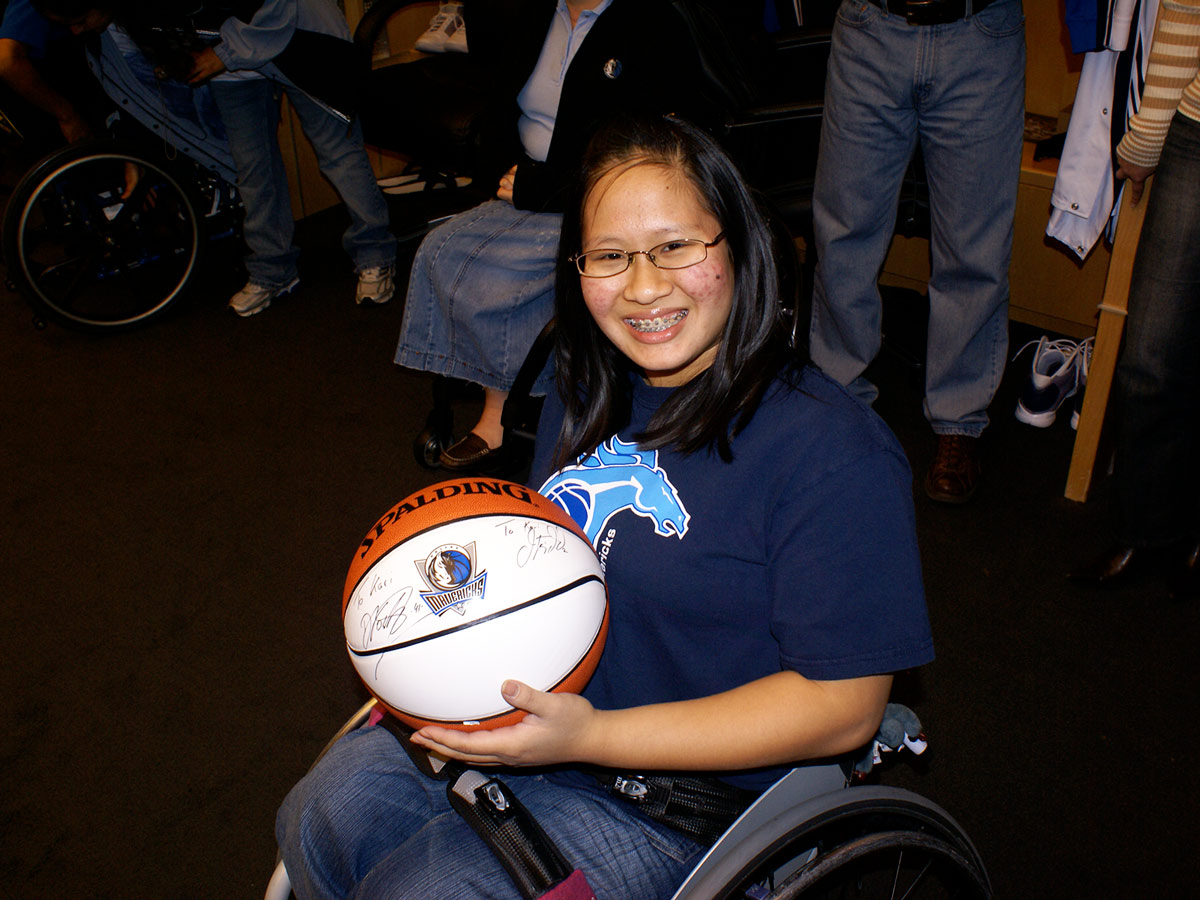 Thai adoptee Kari Banta holding a basketball