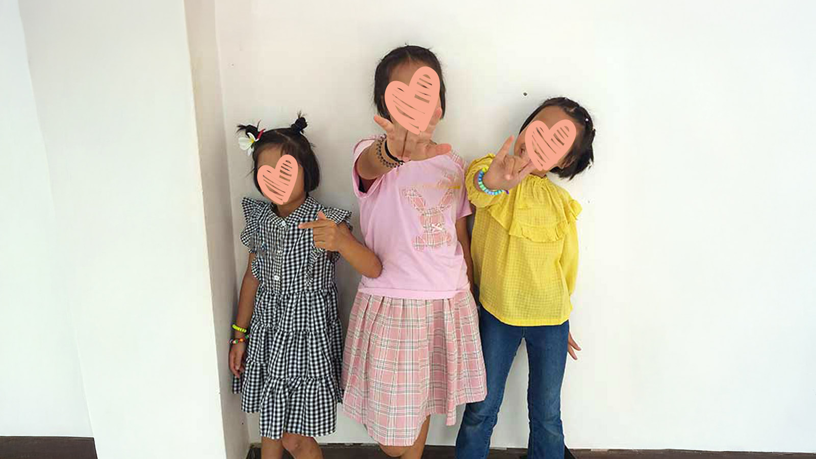 three sisters hold up their hands, waiting for adoption