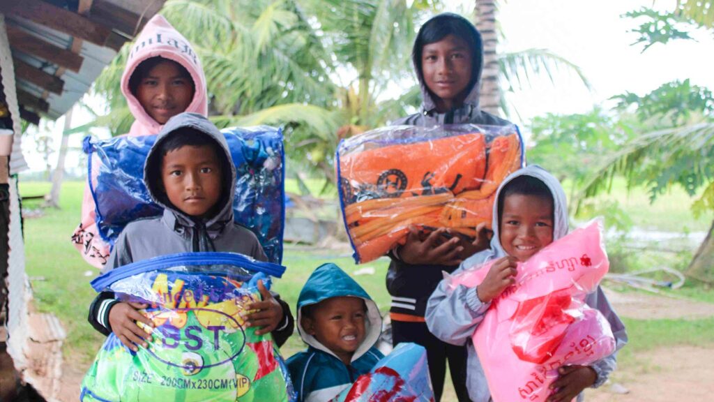 five siblings show off their new coats and blankets, thanks to donors
