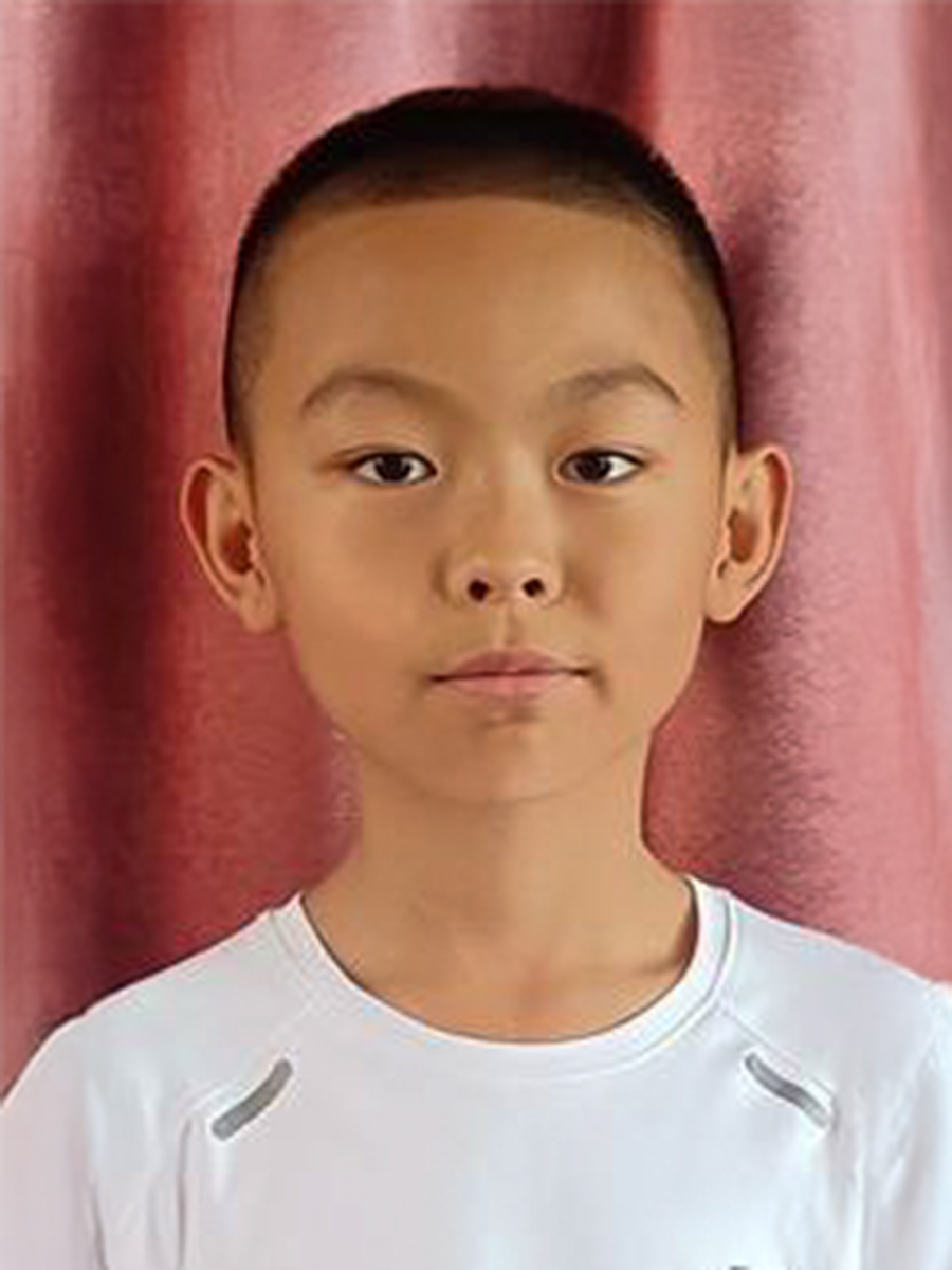 a sponsored boy from China looks into the camera