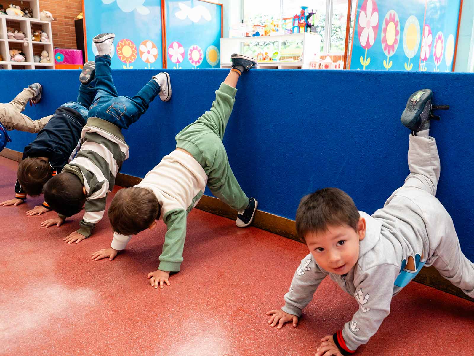 a group of children practice gymnastics during a daycare program