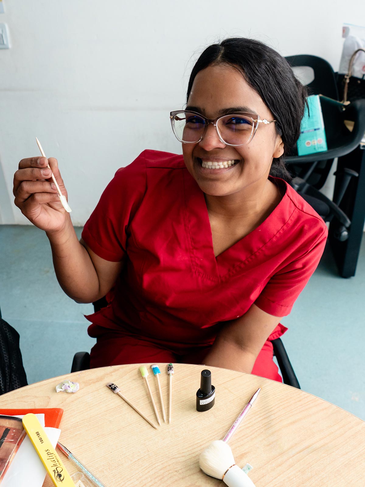 a mom who received a gift of hope smiles as she practices nail art skills