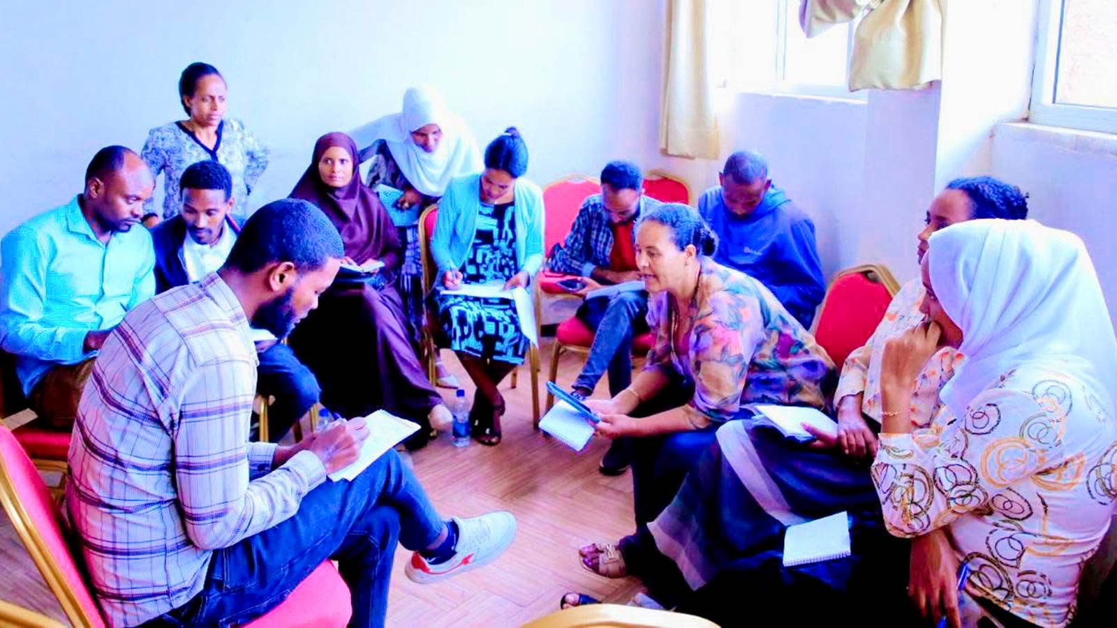 a group of mothers and fathers discuss child safety and foster care in ethiopia