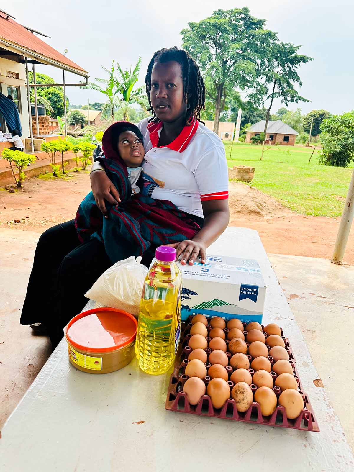 a mom holds her baby with her emergency food rations