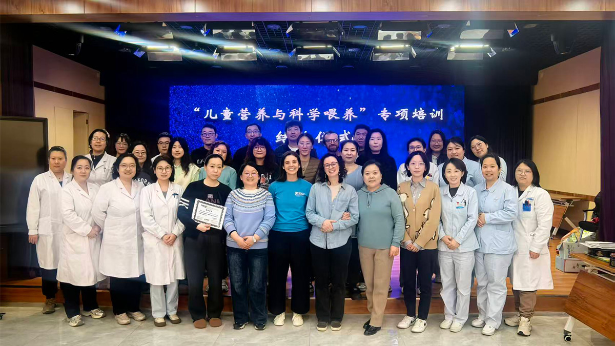 Child Nutrition Program team members celebrate with staff at the Tianjin Children's Welfare Institute in China