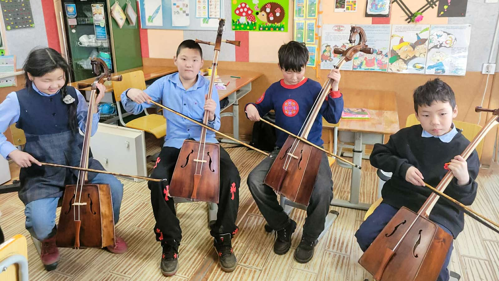 a group of children in Mongolia practice with stringed instruments