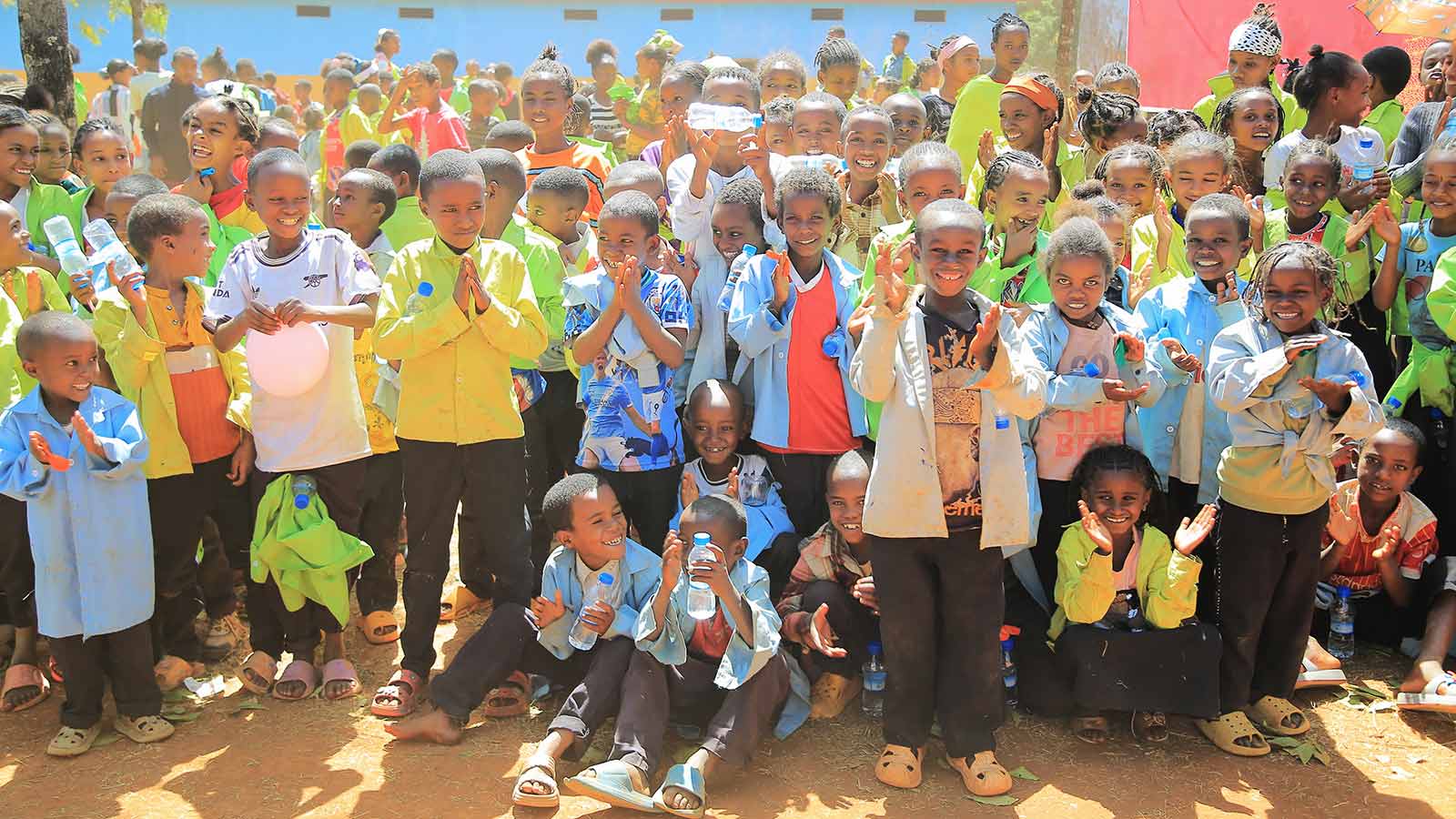 a group of children smile at a celebration in Ethiopia