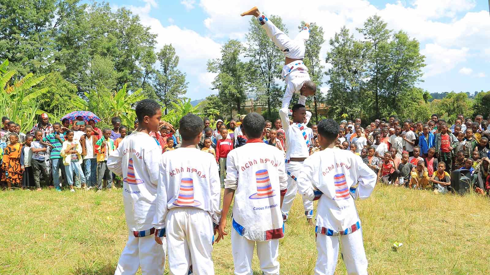 four acrobats perform at a celebration in Ethiopia