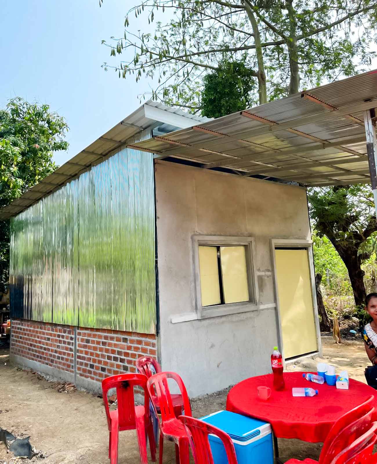a family's new home, constructed with weatherproof tin