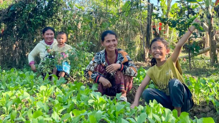 Thida and her family show off their new garden, thanks to Holt donors