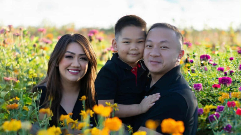 Mang, Thien and Khavong pose together in a flower field