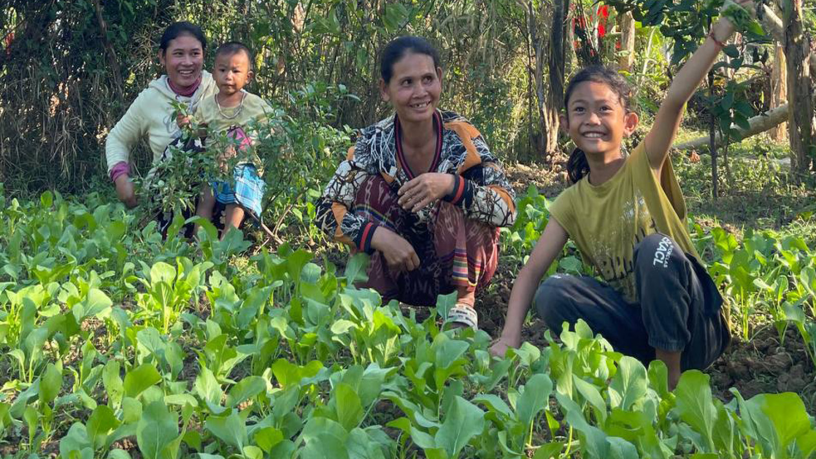 Woman and young girl and children gardening