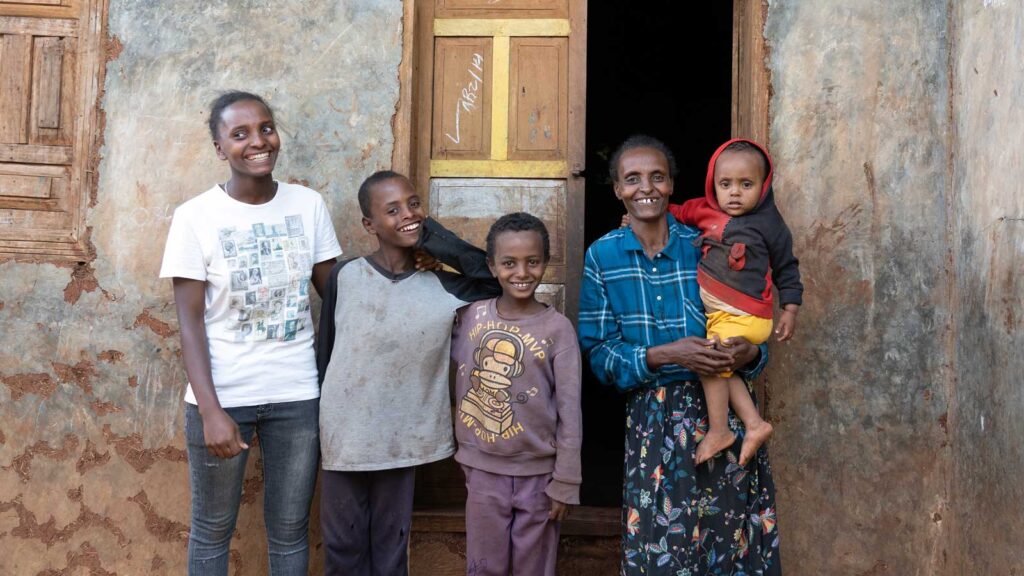 A mom and her four children standing outside their home in Ethiopia